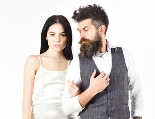 Woman in wedding dress and man in vest. Couple in love, bride and groom in elegant wedding clothes, white background. Wedding concept. Bearded hipster with bride dressed up for wedding ceremony.