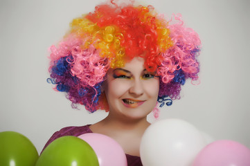 girl in clown wig with balloons