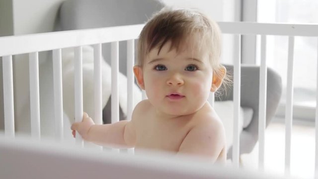 Baby standing in crib 