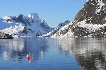 Scenery winter landscape with red buoy in the fishing village of Reine, Lofoten, Norway, above the...