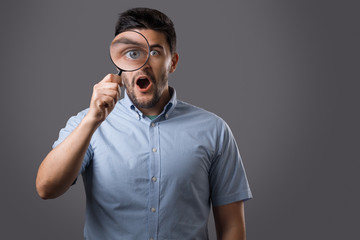 Young man with magnifier