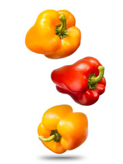 Obraz na płótnie Canvas Falling sweet bell peppers isolated on white background with clipping path