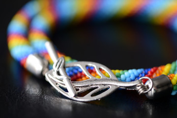 Colorful necklace rainbow colors on a dark background close up