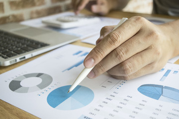 The capitalist is examining the company's finances to prepare his company.