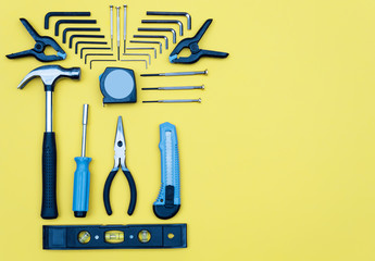 Toolbox set of tools. Home improvement concept on yellow background.