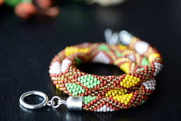 Ethnic style beaded necklace on a dark background close up