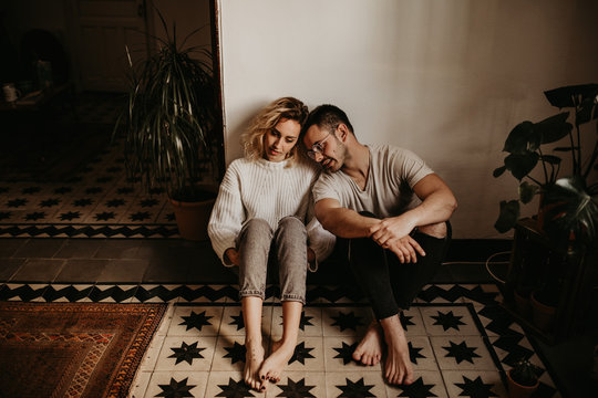 Cheerful Couple Sitting At Home