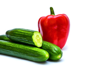 Three cucumbers and a red sweet pepper on a white background.