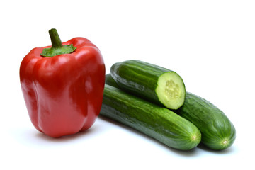 Red peppers and cucumbers on white background