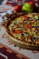 Sausages, salami, tomato and tasty cheese pizza.