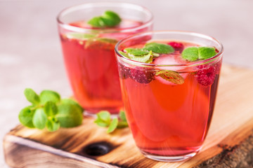 Aperitif with campari, mint and raspberry. Iced lemonade