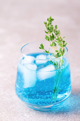 Ice Blue cocktail with thyme. Blue curacao liqueur. Summer