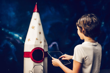 Boy with toy rocket in space