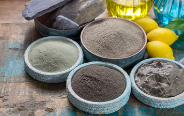 Obraz na płótnie Canvas Ancient nature minerals, different types of clay used for skincare, spa treatments, face masks, gray, black, green and blue mud, close up