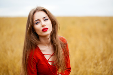 Portrait of a young brunette woman in red dress