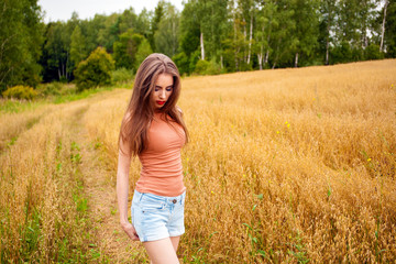 Young beautiful woman in a field, summer outdoors