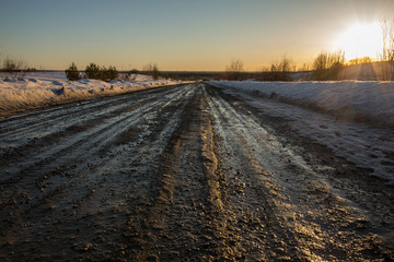 broken rural road on a spring evening