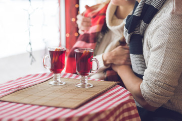 Young couple with glasses of mulled wine