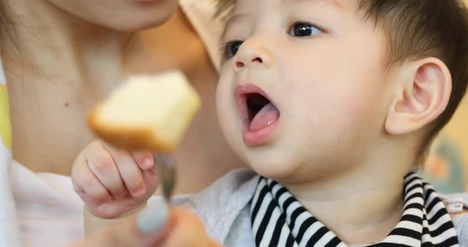 mother play pretend feeding toast with son