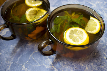 beautiful cups of tea with lemon and mint, top view