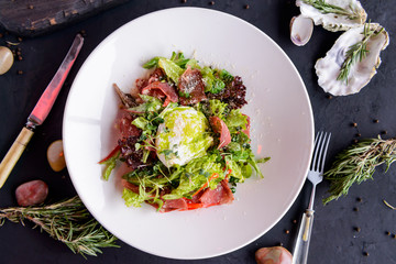 fresh salad in beautiful composition on a concrete background