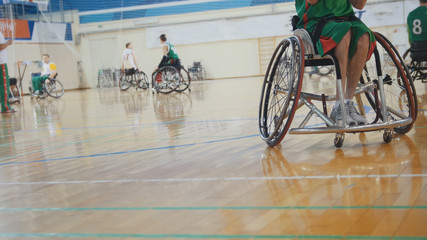 Disabled sportsmen plays wheelchair basketball