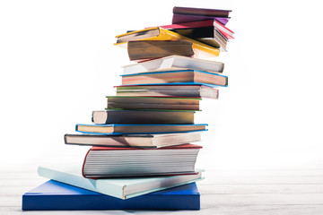 Books stacked in mess on white table