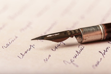Fountain pen on an antique handwritten letter