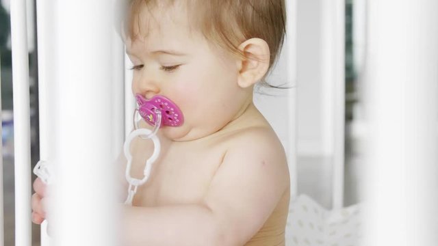 Baby playing in the crib 