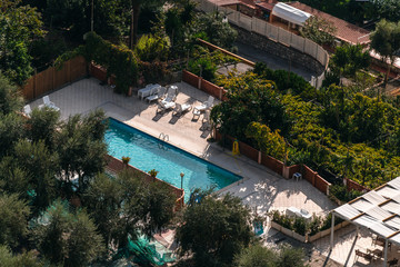 Fototapeta na wymiar aerial view of small rectangle swimming pool in olive trees, Italy, travel vacation concept