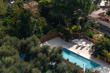 aerial view of small rectangle swimming pool in olive trees, Italy, travel vacation concept