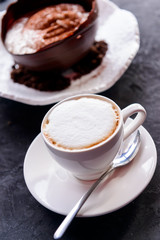 Tiramisu in a large chocolate egg on a concrete background