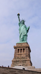 Fototapeta na wymiar Statue of Liberty in New York in front of blue sky, Manhattan, New York City, famous lady