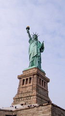Fototapeta na wymiar Statue of Liberty in New York in front of blue sky, Manhattan, New York City, famous lady