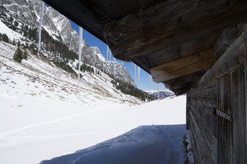 icicles on a hut in the mountains