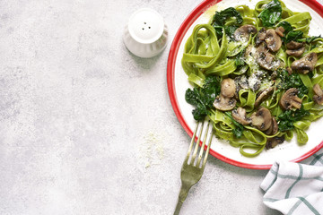 Spinach tagliatelle with mushrooms and cream.Top view with copy space.