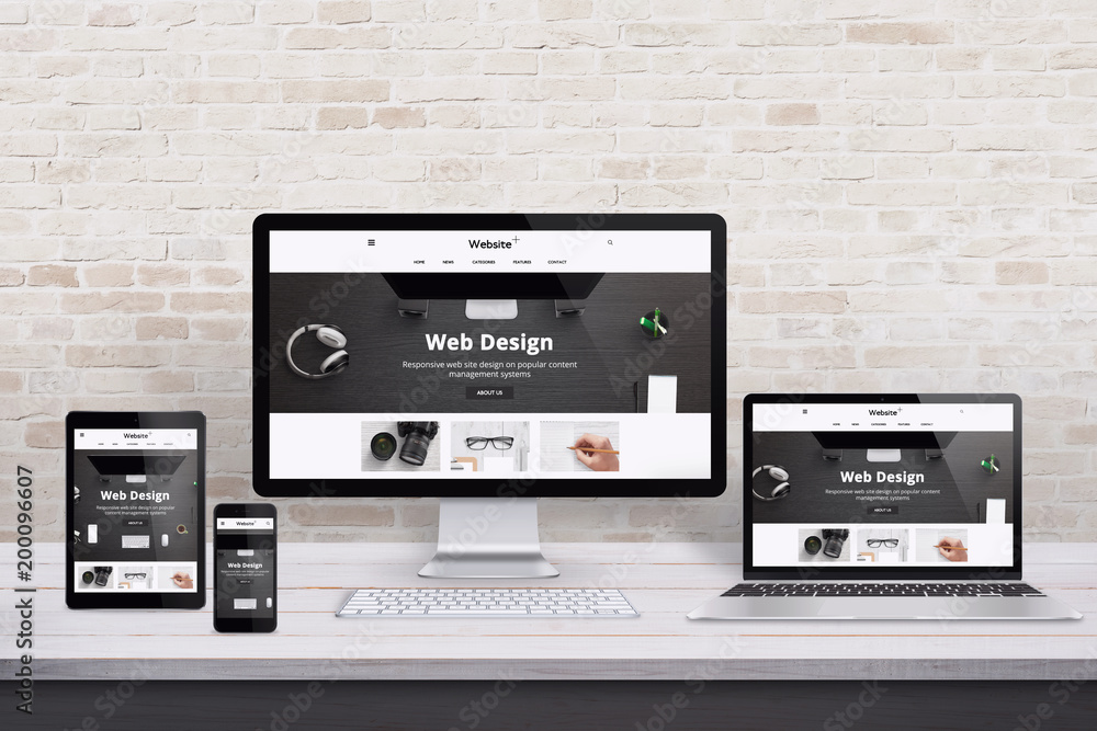 Wall mural multiple display devices with modern flat design web site presentation. wooden desk and brick wall i