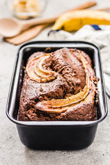 Chocolate chip banana bread on light concrete background. Selective focus, space for text.