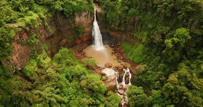 Exotic aerial view of Cimarinjung waterfall from a drone at Ciletuh Geopark, Sukabumi, West Java, Indonesia. Shot in 4k resolution