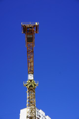 Yellow construction crane isolated 