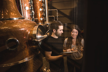 Man and woman working in beer factory