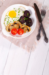 Breakfast - fried egg with mushrooms, tomatoes and black pudding