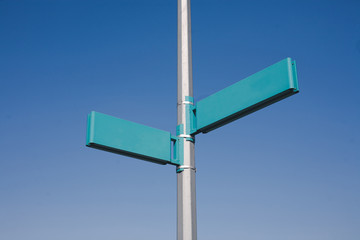 Empty copy space signpost information isolated on blue sky.