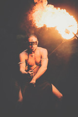 Awesome fire show at the waterfall. Brutal muscle man