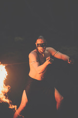 Awesome fire show at the waterfall. Brutal muscle man