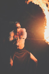 Awesome fire show at the waterfall. Brutal muscle man