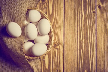 eggs in a basket on a wooden table