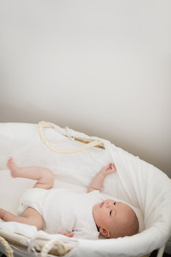 Newborn baby sleeping in moses basket