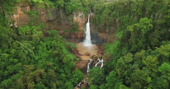 Top view of Cimarinjung waterfall with green trees at Ciletuh Geopark, Sukabumi, West Java, Indonesia. Shot in 4k resolution