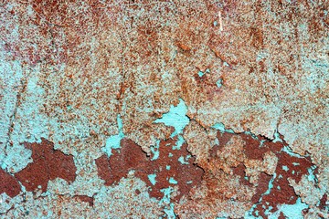 Old shabby wall texture with cracked peeling paint